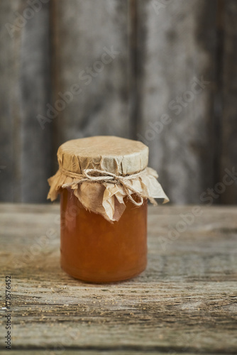 Close up of brown jam on wooden rustic background