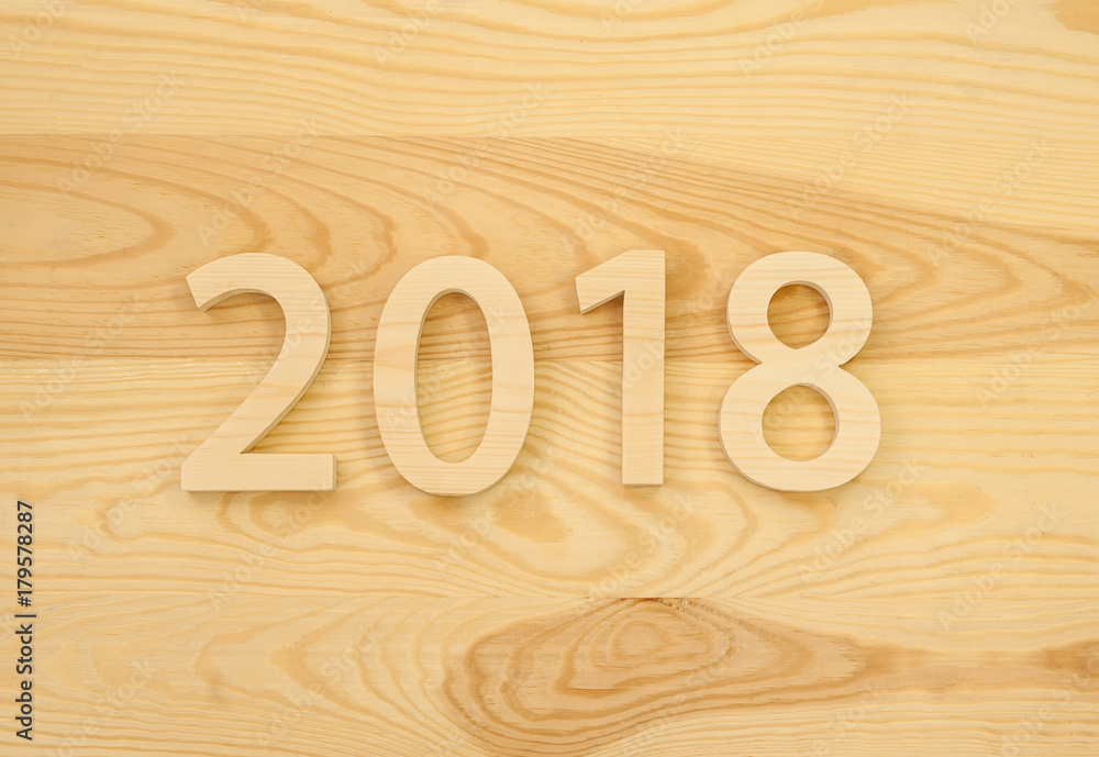 Wooden figures forming 2018, carved from light wood on the background of old wood. New Year Idea, postcard, poster, greetings. Festive decor. Wooden figures forming 2018, carved from light wood on the background of old wood. New Year Idea, postcard, poster, greetings. Festive decor.