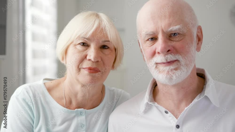 Portrait of happy senior couple at home. Senior man and his wife. Happy family enjoying time together. White background Portrait of happy senior couple at home. Senior man and his wife. Happy family enjoying time together. White background