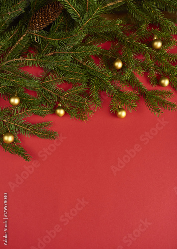 Christmas tree with christmas decorations on red background. design mockup