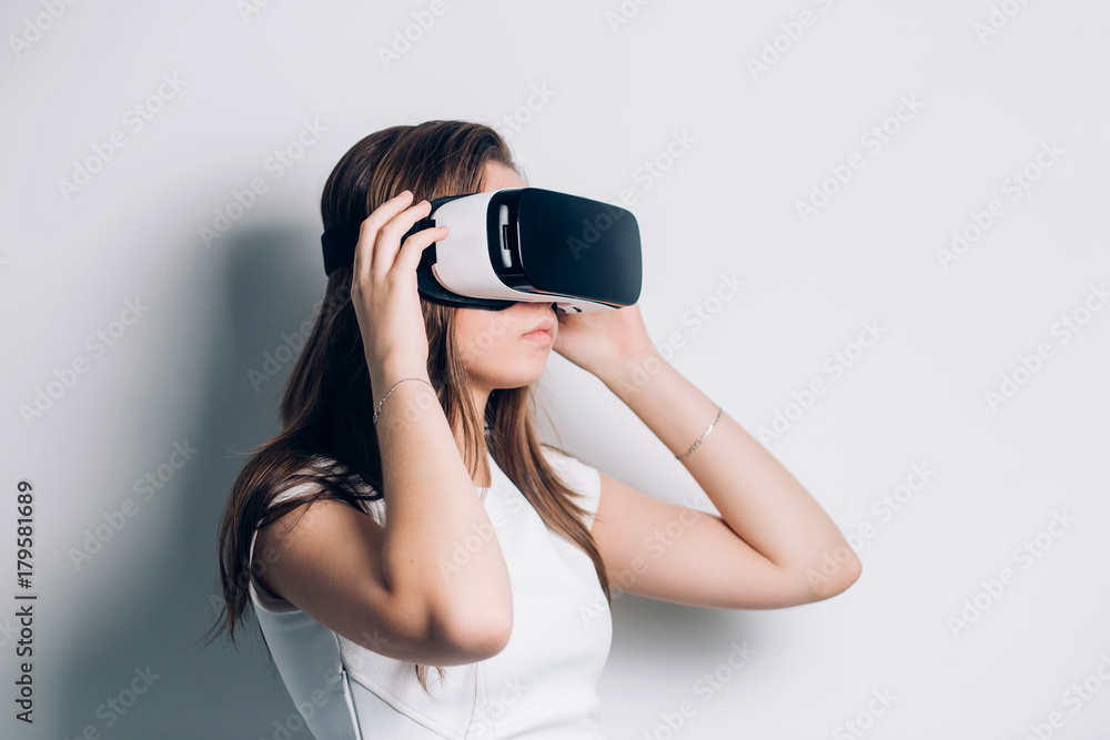 Woman in VR headset looking up at the objects in virtual reality. Woman in VR headset looking up at the objects in virtual reality.