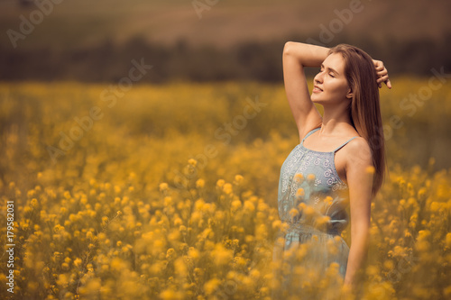 Young attractive woman in dress at flower field.
