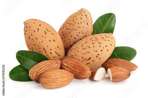 Group of almond nuts with leaves isolated on white background