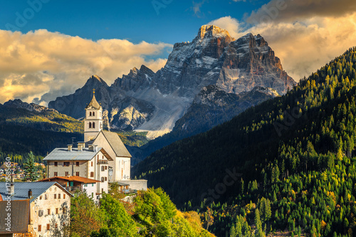 Amazing autumn landscape with church on the hill, Dolomites, Italy