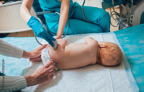 Doctor and little boy patient. Ultrasound equipment. Sonography. Hip dysplasia