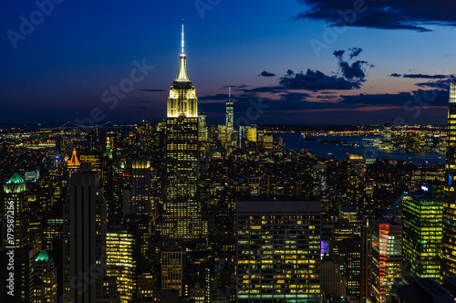City skyline and Empire State Building at night in NYC  USA