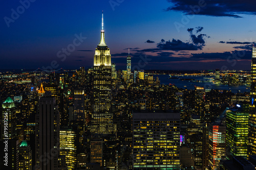 City skyline and Empire State Building at night in NYC, USA