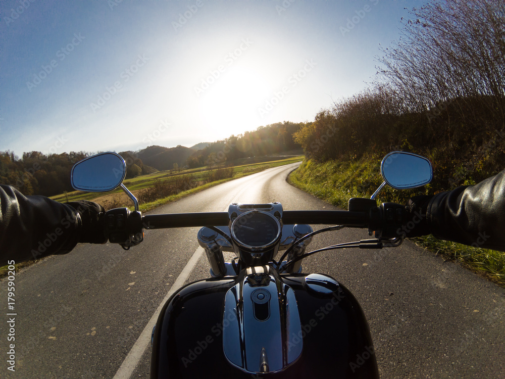 Fototapeta premium Zdjęcie z pierwszej osoby przedstawiające motocyklową przygodę na wsi
