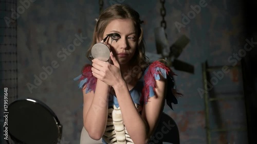 beautiful girl doing makeup before the holiday halloween