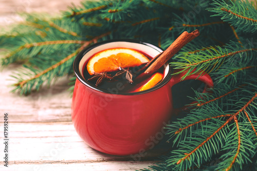 Hot mulled wine. Christmas tree branches and cones. Holidays.