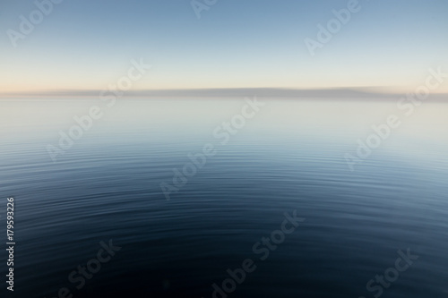Abstract image of smooth ripples emanating across a body of water