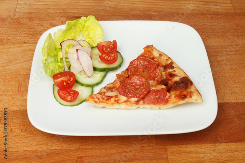 Pizza and salad on a tabletop