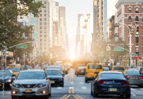 Traffic along 3rd Avenue in New York City with Sunlight Background