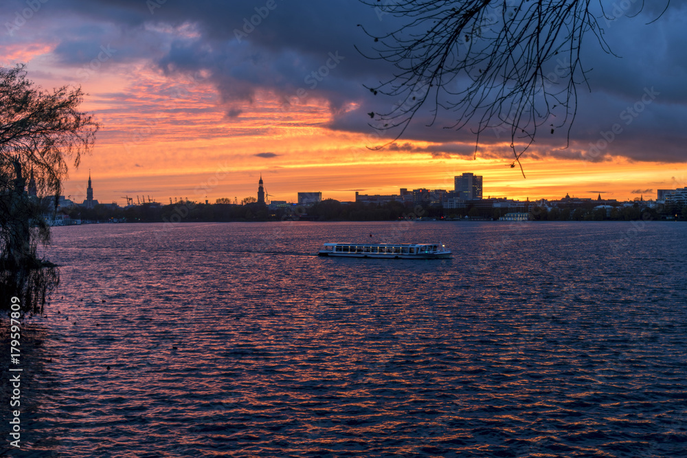 sunset panorama over the lake Alster into the city of Hamburg Germany