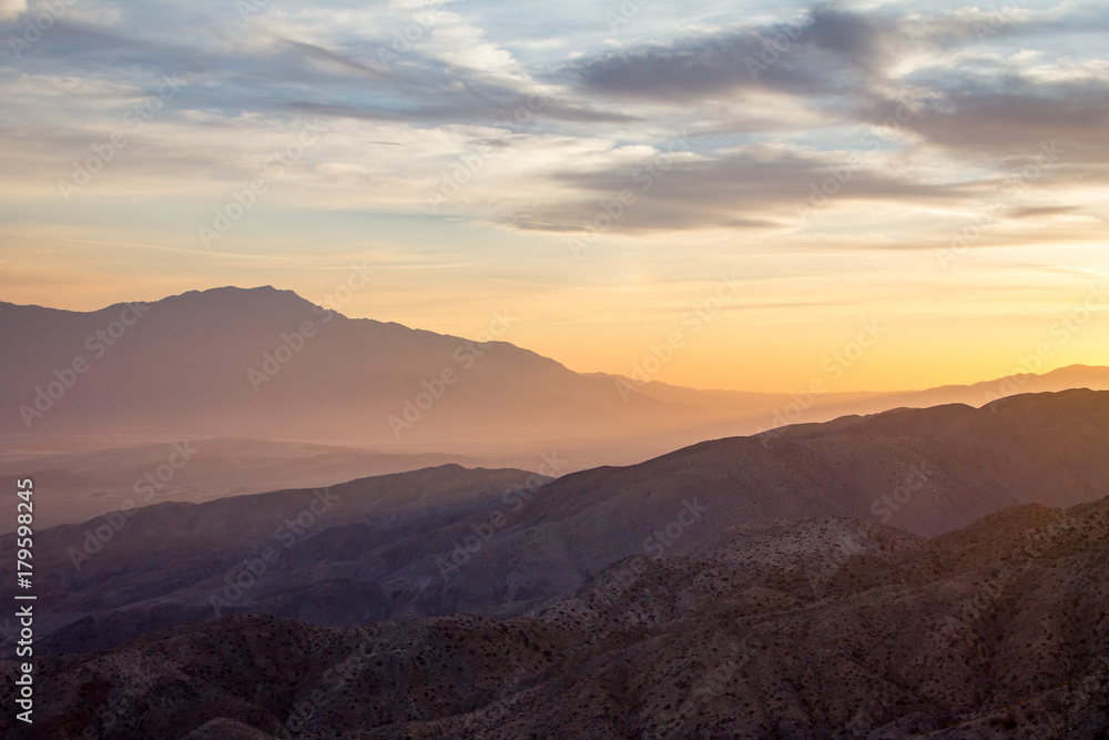 Fototapeta premium Colorful sky above a desert mountain landscape scene in California