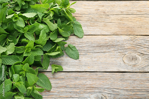 Fresh mint leafs on grey wooden table