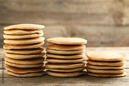 Tasty pancakes on grey wooden table