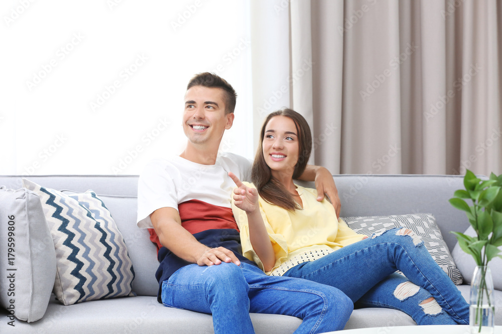 Young couple on sofa at home