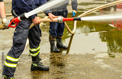 Hose eliminating mud after flooding.
