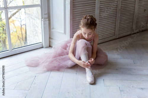 Ballerina puts pointe shoes photo