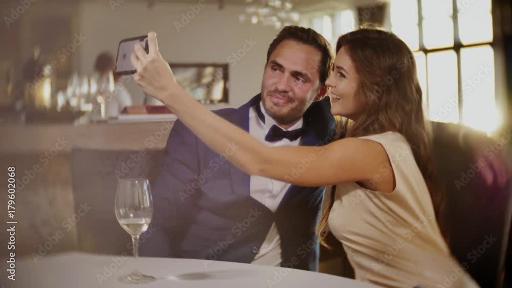 Beautiful couple taking selfie in a restaurant Beautiful couple taking selfie in a restaurant