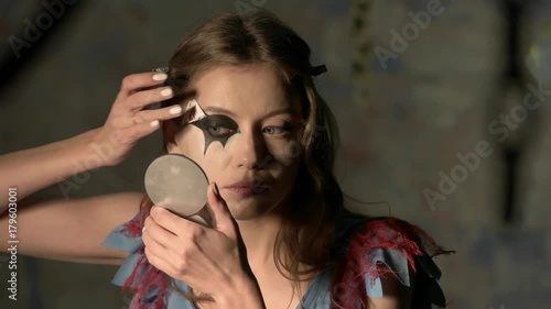 beautiful girl doing makeup before the holiday halloween
