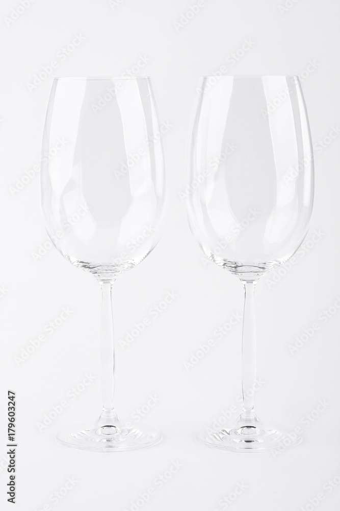 Two empty wine glasses over white. Pair of empty glasses for wine isolated on white background.