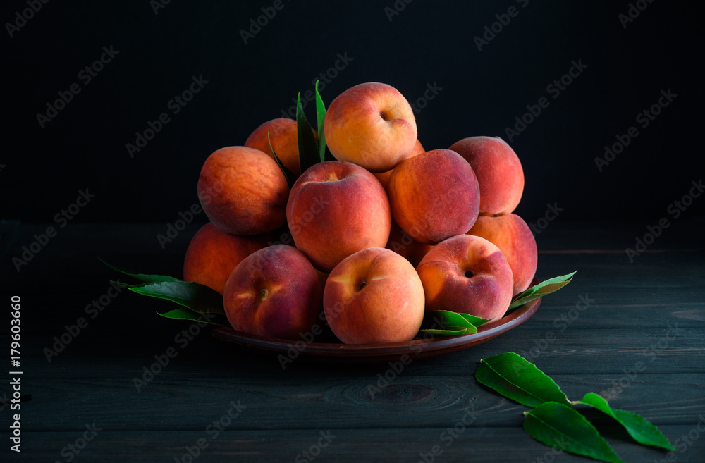 Many sweet peaches in a plate on the table Many sweet peaches in a plate on the table