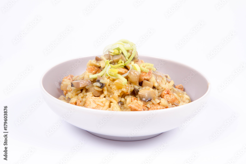Risotto with mushrooms and chicken decorated with leek on a white background Risotto with mushrooms and chicken decorated with leek on a white background