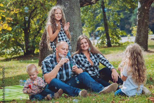 Young family with cheerful children in the park