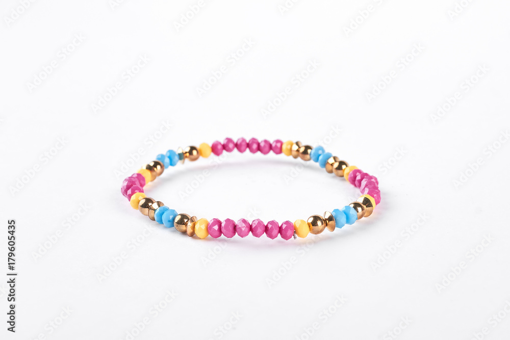 Colorful childrens bracelet for girls. Multicolored beaded kids bracelet isolated on white background.