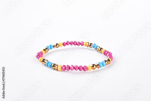 Colorful childrens bracelet for girls. Multicolored beaded kids bracelet isolated on white background.