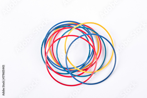 Set of colored bracelets, top view. Collection of plastic multicolored bangles on white background. Girls fashion accessories.