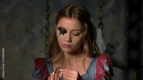 beautiful girl doing makeup before the holiday halloween