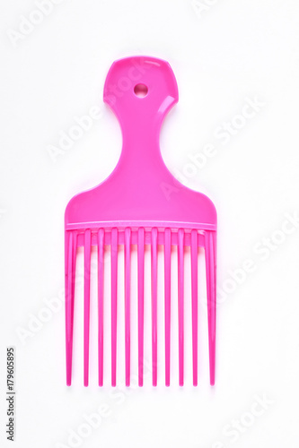 Pink professional afro comb. Hairdresser vivid color afro comb isolated on white background.