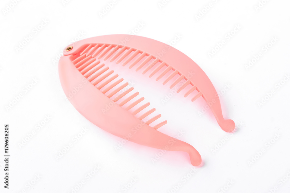 Pink hair pin on white background. Plastic hair pin with teeth isolated on white background. Pink hair pin on white background. Plastic hair pin with teeth isolated on white background.