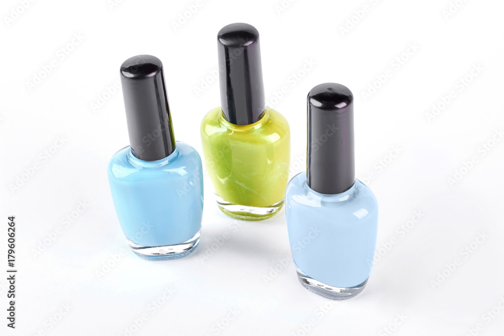 Collection of nail polishes on white background. Blue and yellow bottle of nail varnish over white background. Collection of nail polishes on white background. Blue and yellow bottle of nail varnish over white background.