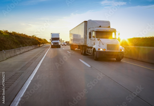 Semi truck on highway at sunset © 5m3photos