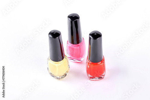 Nail varnish collection on white background. Three bottles with nail varnish of different colors, white background. © DenisProduction.com