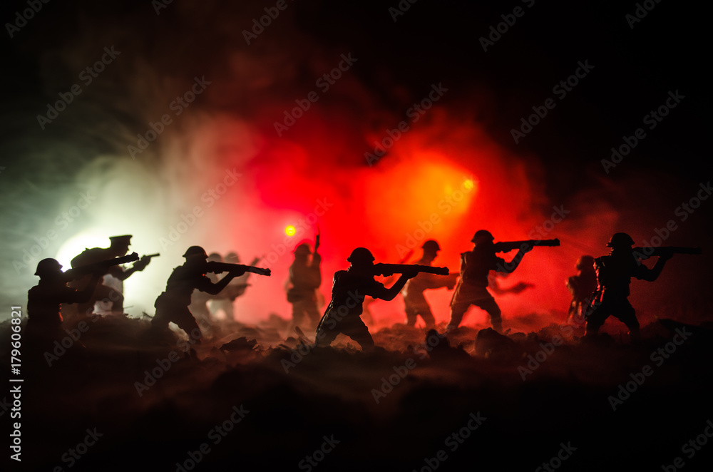 Fototapeta premium War Concept. Military silhouettes fighting scene on war fog sky background, World War Soldiers Silhouettes Below Cloudy Skyline At night. Attack scene. Armored vehicles. Selective focus