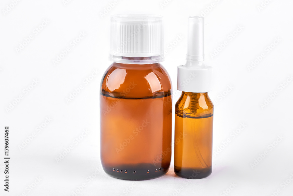 Medication to treat running nose. Two brown glass bottles with medicine for cold treatment. Cold and treatment concept. Medication to treat running nose. Two brown glass bottles with medicine for cold treatment. Cold and treatment concept.