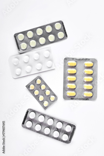 Pills in blisters on white background. Medicaments isolated on white background, top view.