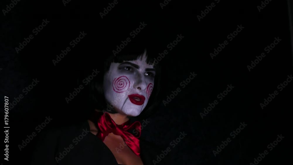 pretty woman in horror style make up sings a song on dark background pretty woman in horror style make up sings a song on dark background