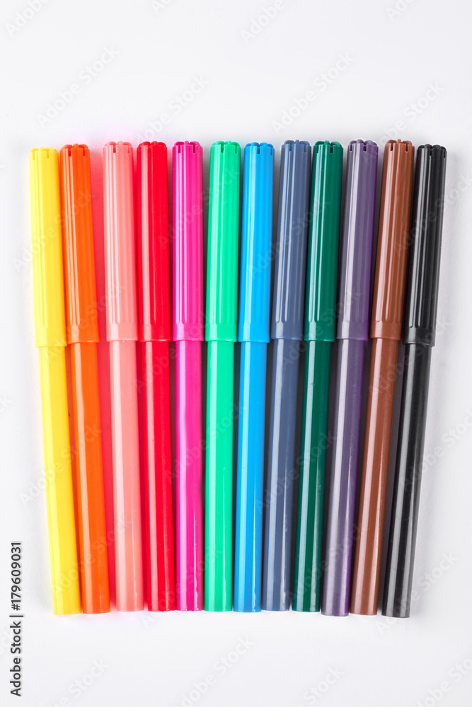 Fototapeta premium Colorful markers on white background. Rainbow collection of markers over white background.