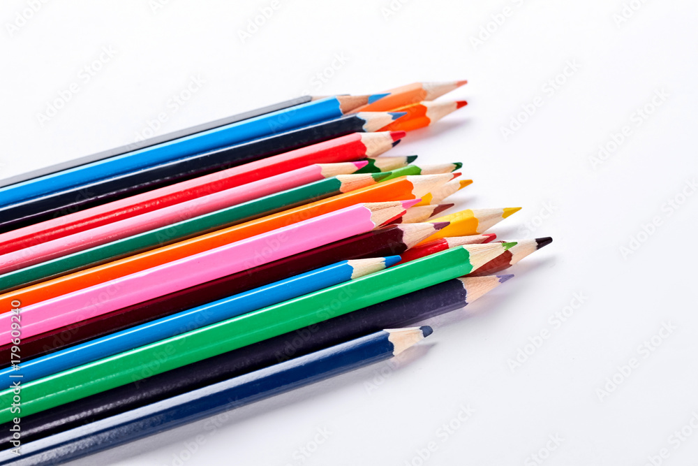 Pensils of different colors on white background. Variety of colorful pencils on white background. Equipment for drawing at school. Pensils of different colors on white background. Variety of colorful pencils on white background. Equipment for drawing at school.