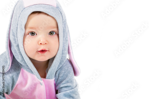 Portrait of a beautiful little girl in a hare suit. Child on a white background