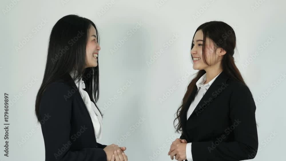 4k of asian businesswomen standing and talking on white background 4k of asian businesswomen standing and talking on white background