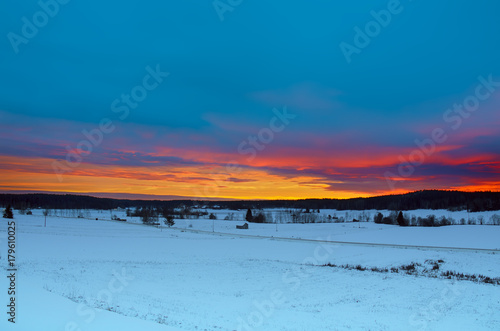 Winter sunset landscape with dramatic sky in Sweden, north scandinavian seasonal hipster background.