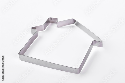 House pastry cutter shape. Metal house shape for cake baking. Aluminium house shaped mold for cake decorating. photo