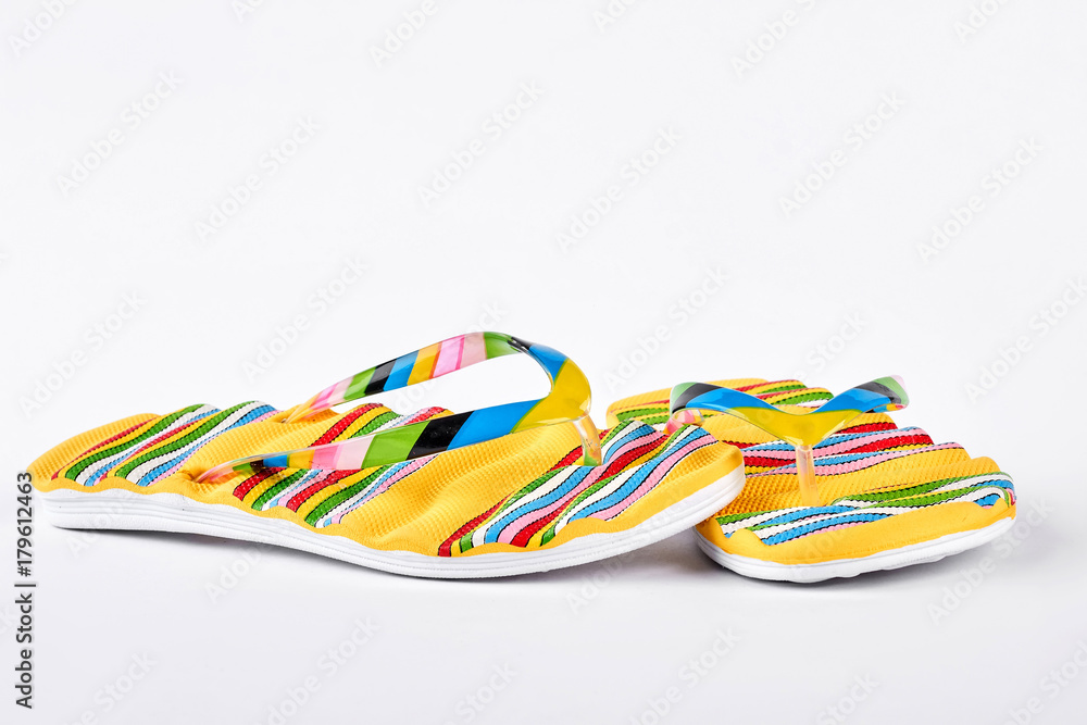 Woman fashion design flip flops. Yellow striped flip flops on white background. Summer fashion fotwear on sale.